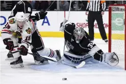  ??  ?? LOS ANGELES: Chicago Blackhawks center Jonathan Toews, left, tries to score on Los Angeles Kings goalie Jonathan Quick during the third period of an NHL hockey game, Saturday, in Los Angeles. The Kings won 3-2. — AP