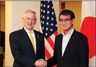  ?? AP/KIMIMASA MAYAMA ?? U.S. Defense Secretary James Mattis and Japanese Foreign Minister Taro Kono stop for a photo before the start of their meeting Friday at the Foreign Ministry in Tokyo.