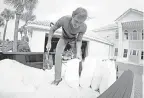  ?? NICK TOMECEK/AP ?? Rick Johnson fills sand bags at his Okaloosa Island home in Fort Walton Beach, Fla.