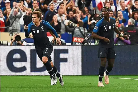  ?? — AFP ?? Working together: France’s Antoine Griezmann (left) celebratin­g after scoring during the Nations League match against Germany at the Stade de France on Tuesday.