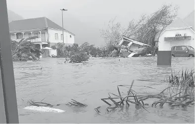  ?? RINSY XIENG/AFP/GETTY IMAGES ?? A handout picture on the Twitter account of RCI Guadeloupe shows a flooded street on the French island of Saint Martin, after it was hit with high winds from Hurricane Irma.