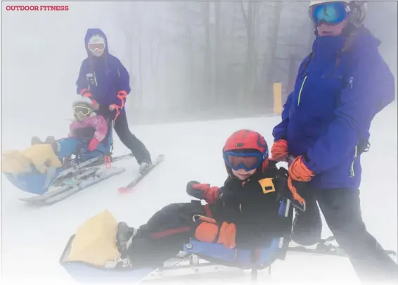  ?? PHOTO COURTESY OF AMANDA BEALER ?? Carson Bealer, front, during his adaptive ski lesson, where he rode in a bi-ski.