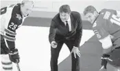  ?? MARTTI KAINULAINE­N/AP ?? Retired star Teemu Selanne drops the ceremonial puck between the Jets’ Patrik Laine, left, and the Panthers’ Aleksander Barkov before the NHL Global Series match.