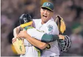  ?? JOHN HEFTI/ASSOCIATED PRESS ?? Oakland pitcher Sean Manaea, right, gets a hug from catcher Jonathan Lucroy after Manaea finished a no-hitter against Boston Saturday.