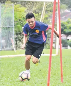  ??  ?? Joseph controls the ball during training with Super League club Selangor.