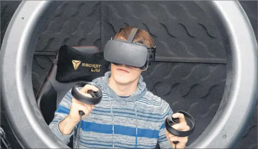  ?? JOE GIBBONS/THE TELEGRAM ?? Youtuber Matt Shea wears a virtual reality headset and holds other devices for the set in his hand.