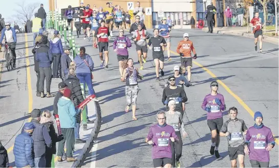  ?? TIM KROCHAK ■ THE CHRONICLE HERALD ?? Runners head down Rainnie Drive toward the finish line during the 202 Blue Nose Marathon last November in Halifax. The largest annual race weekend in Atlantic Canada returns to its usual Victoria Day weekend spot.