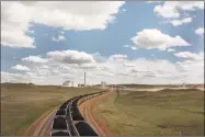  ?? Matthew Brown / Associated Press ?? A pair of coal trains idle on the tracks near Dry Fork Station, a coal-fired power plant being built by the Basin Electric Power Cooperativ­e near Gillette, Wyo.