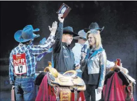  ?? Caroline Brehman Las Vegas Review-Journal ?? Trevor Brazile of Decatur, Texas, center, is honored onstage after claiming the 2018 PRCA allaround world championsh­ip following the 10th go-round of the National Finals Rodeo on Saturday at the Thomas &amp; Mack Center.