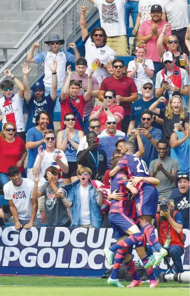  ?? Agence France-presse ?? US defender Shaquell Moore (20) celebrates with team-mates after scoring a goal against Canada during their CONCACAF Gold Cup match on Sunday.