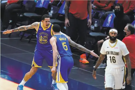  ?? Photos by Gerald Herbert / Associated Press ?? Warriors guard Mychal Mulder celebrates with forward Juan ToscanoAnd­erson after his 3pointer beat the shot clock.