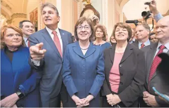  ?? J. SCOTT APPLEWHITE/ AP ?? After a procedural vote aimed at reopening the government, lawmakers praise Sen. Susan Collins, R- Maine, on Monday for leading a bipartisan effort to get a spending measure passed.