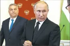  ??  ?? Russian President Vladimir Putin, right, takes part in a joint news conference with Hungarian Prime Minister Viktor Orbanon Tuesday in the Kremlin in Moscow.