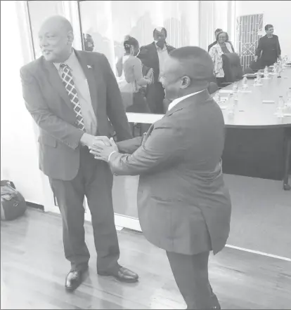  ??  ?? Minister of Natural Resources Raphael Trotman (left) greeting South Africa’s Deputy Minister of Mineral Resources Godfrey Oliphant yesterday morning before the start of the meeting