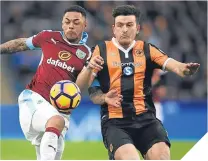  ??  ?? ■ Andre Gray and Hull’s Harry Maguire tussle.