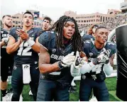  ?? PHOTO] [AP ?? Colorado wide receiver Laviska Shenault Jr. joins teammates to sing the school song on Oct. 6. The electric playmaker has vaulted into the conversati­on for the Heisman Trophy.