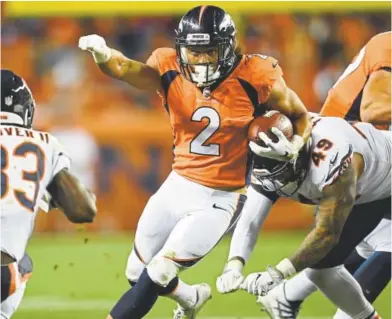  ?? RJ Sangosti, The Denver Post ?? Running back Phillip Lindsay turns upfield as the Broncos take on the Chicago Bears on Saturday night at Broncos Stadium at Mile High. Lindsay had six carries for 32 yards in Denver’s 24-23 loss.