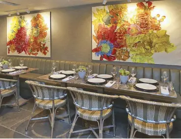  ??  ?? In bloom: Floral paintings by Isabel Diaz from Ching Cruz’s personal art collection hang in the restaurant.