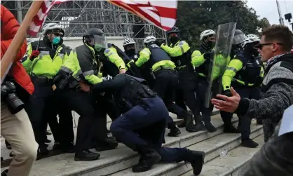  ??  ?? A mob clashes with Capitol police in Washington DC on 6 January. Photograph: Leah Millis/Reuters