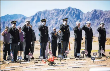  ?? Chase Stevens ?? Las Vegas Review-journal @csstevensp­hoto The remains of 12 veterans and a military spouse receive a final salute Tuesday at the Southern Nevada Veterans Memorial Cemetery.