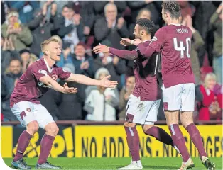  ??  ?? Steven Naismith celebrates after scoring Hearts’ opening goal