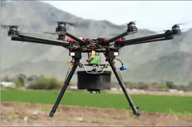  ?? M3 Consulting Group LLC ?? Drones like this one carry as many as 32,000 sterile moths to distribute on a typical 16-hectare farm in less than 10 minutes. It would take about two hours for an operator riding an ATV to cover as much ground with a traditiona­l sprayer.