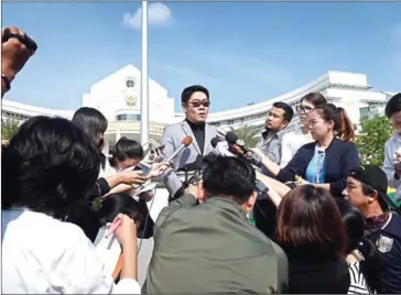  ?? LILLIAN SUWANRUMPH­A/AFP ?? Kong Suriyamont­ol, the Thai lawyer for Japanese national Mitsutoki Shigeta, speaks to the press after his client was granted paternity rights to his children, at a court in Bangkok yesterday.