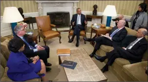  ?? The Associated Press ?? SECURITY MEETING: President Barack Obama, joined by from left, Commerce Secretary Penny Pritzker, former IBM CEO Sam Palmisano, former National Security Adviser Tom Donilon, and Homeland Security Secretary Jeh Johnson, talks to media in the Oval Office of the White House, on Feb. 17, in Washington.