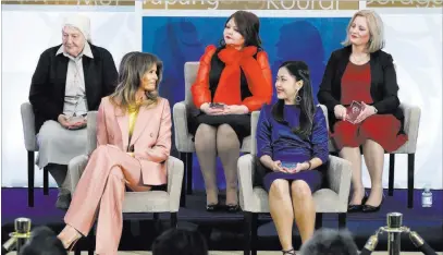  ?? Jacquelyn Martin ?? The Associated Press First lady Melania Trump smiles at Sirikan Charoensir­i of Thailand, after presenting the Internatio­nal Women of Courage awards Friday at the State Department in Washington. At top from left are Sister Maria Elena Berini, of Italy,...