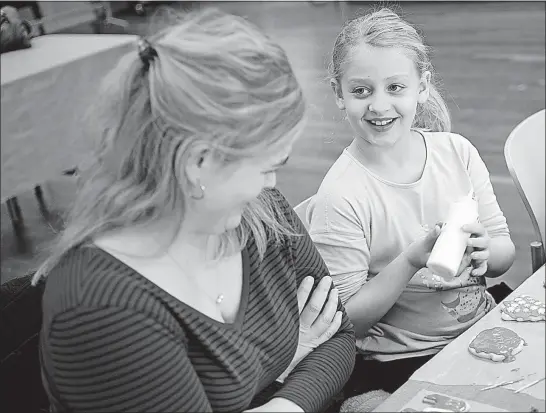  ??  ?? ABOVE: Jennifer Dahlgren, of Powell, joined her daughter, Lauren, 8, in decorating cookies with all-natural icing during Saturday’s class. “It doesn’t taste like spinach or kale,” Lauren said of the green icing that was made of those vegetables. LEFT:...