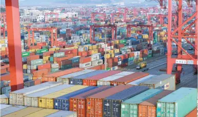  ?? — Reuters ?? Containers are seen at the Yangshan Deep Water Port, part of the Shanghai Free Trade Zone, in Shanghai, China.