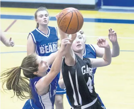  ?? JULIE JOCSAK/POSTMEDIA NEWS ?? Alexandra Klauck of the Lakeshore Gators beats Allyce Andrews of the Port Colborne Bears to the rebound during the Tribune Girls Basketball Tournament at Port Colborne High School on Thursday.