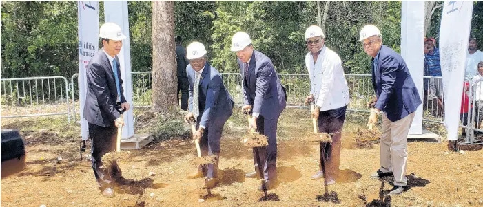  ?? PHOTO BY JANET SILVERA ?? Prime Minister Andrew Holness (centre) is assisted by Minister of Tourism Edmund Bartlett (second right ) in officially breaking ground last Friday for the Rhyne Park developmen­t in Montego Bay, St James, that will see 754 mixed units being constructe­d. Sharing in the occasion (from left) are Baoguo Chen, general manager, Henan Fifth Constructi­on Group; Senator Pearnel Charles Jr, minister without portfolio in the Ministry of Economic Growth and Job Creation; and Norman Brown, chairman of the Housing Agency of Jamaica.