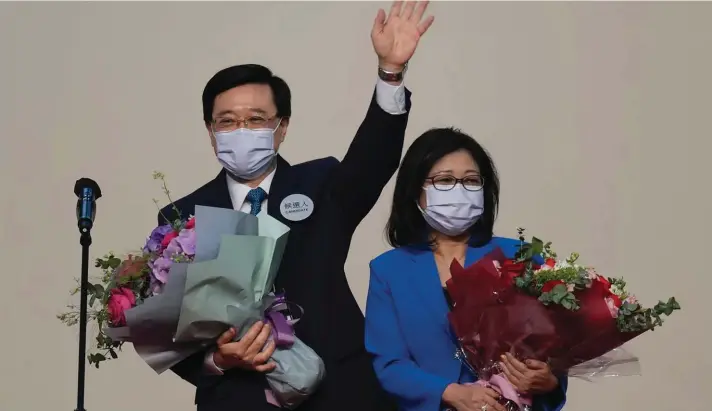  ?? Photo: AP ?? John Lee, former No. 2 official in Hong Kong and the only candidate for the city's top job, celebrates with his wife after declaring his victory in the chief executive election of Hong Kong in Hong Kong, Sunday, May 8, 2022. Lee was elected as Hong Kong's next leader Sunday by an election committee comprised of nearly 1,500 largely pro-Beijing members.