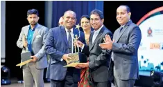  ??  ?? Three Sinha Group of Companies Managing Director Manjula Ariyakumar­a receiving the Gold awards
