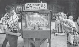  ?? Houston Chronicle file ?? Bruce Gillikin, 20, a sophomore at Sam Houston State Teachers College, and Beverly Landrum, 17, a senior at Sam Houston High, play K.O. Fighters during their romp through Playland Park in Houston.