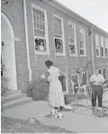  ?? AP PHOTO/GENE HERRICK ?? In 1956, Theresser Caswell, 13, of Claxton, Tenn., one of 12 African American pupils attending the newly integrated Clinton High School, walks to the front entrance in Clinton, Tenn.