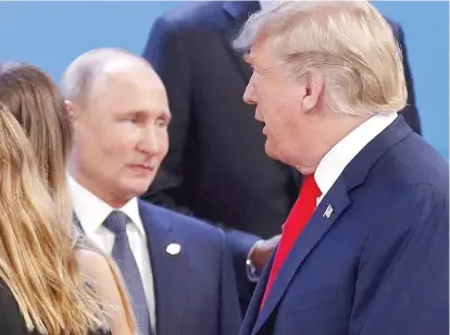  ?? AP ?? Russia’s President Vladimir Putin watches President Donald Trump walk past him last month in Buenos Aires, Argentina.