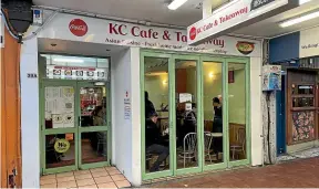  ?? ?? Despite its humble road-front position, KC Cafe – and its intriguing 160-item menu, below – is a Wellington institutio­n.