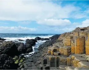  ?? PHOTOS: CARISSA GREENLEES ?? Left: With the cross of St. Andrew proudly waving, the Eilean Donan Castle stands a lonely vigil on the Isle of Skye, Scotland. Right: The Giant’s Causeway in Ireland is aptly named.