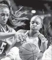  ??  ?? TEXAS A&M forward Anriel Howard, left, and UCLA guard Kennedy Burke fight for a ball.