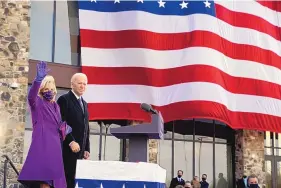  ?? EVAN VUCCI/ASSOCIATED PRESS ?? President-elect Joe Biden stands with his wife Jill Biden at the Major Joseph R. “Beau” Biden III National Guard/Reserve Center Tuesday in New Castle, Del.