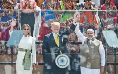  ??  ?? US First Lady Melania Trump, President Donald Trump and India’s Prime Minister Narendra Modi wave at the crowd during a “Namaste (Welcome) Trump” rally at the Sardar Patel Stadium in India yesterday. — AFP