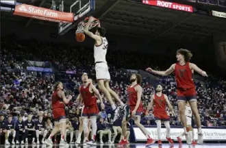  ?? Young Kwak/Associated Press ?? Gonzaga University center Chet Holmgren dunks against Saint Mary’s College on Feb. 12 in Spokane, Wash. Gonzaga is sure to be among the top ranked teams in the NCAA Basketball Tournament.