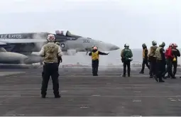  ?? (AP) ?? JOINT NAVAL DRILL — A F-18E fighter jet prepares to take off from USS Theodore Roosevelt aircraft carrier on Thursday, April 11, 2024, during a three-day joint naval exercise by the U.S., Japanese and South Korea at the East China Sea amid tension from China and North Korea.
