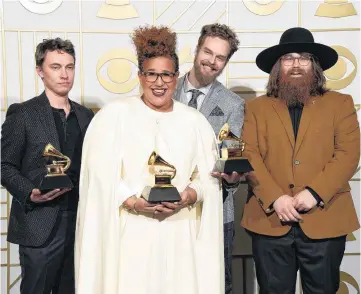  ??  ?? Heath Fogg, from left, Brittany Howard, Steve Johnson and Zac Cockrell, of Alabama Shakes, pose in the press room with the awards for best alternativ­e music album for “Sound & Color,” best rock song for “Don’t Wanna Fight,” and best rock performanc­e...