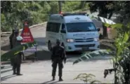  ?? SAKCHAI LALIT — ASSOCIATED PRESS ?? An ambulance with flashing lights leaves the cave rescue area in Mae Sai, Chiang Rai province, northern Thailand, on Monday.