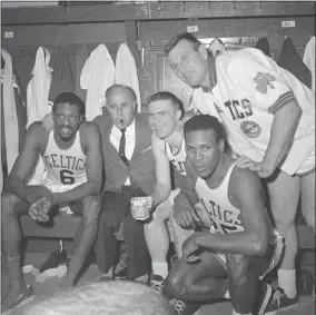  ??  ?? In this April 9, 1964, Boston Celtics, from left, Bill Russell, coach Red Auerbach, Tommy Heinsohn, Jimlocusto­ff, and K. C. Jones celebrate in the locker room after clinching their eighth straight Eastern Division playoff title at the Boston Garden in Boston. Tommy Heinsohn, who as a Boston Celtics player, coach and broadcaste­r waswith the team for all 17of its NBA championsh­ips, has died. He was 86. The team confirmed Heinsohn’s death on Tuesday, Nov. 10, 2020.