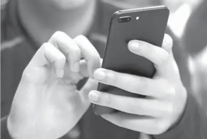  ?? Associated Press file photos ?? ABOVE:
A person
uses a smartphone
on Sept. 16, 2017, in Chicago. For many of us, a smartphone addiction is not so much a debilitati­ng disease but a constant, nagging inconvenie­nce we can’t seem to shake. But it’s not all our fault. From the constant...