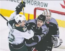  ?? CANDICE WARD/CALGARY HITMEN ?? The Hitmen’s Dakota Krebs blocks Everett’s Brendan Lee in front of goalie Jack Mcnaughton in Sunday’s game.